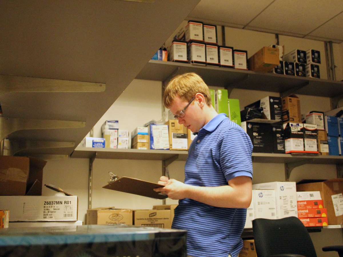 Peter O'Halloran checks supplies at his job. O'Halloran works full-time at a nonprofit in Philadelphia.