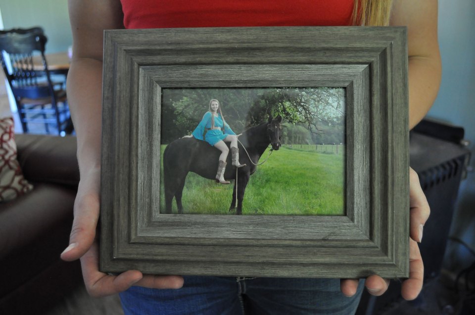 Ronnie Kinsman holds her senior photo on June 2, 2018 in her home in Onalaska, Washington. Kinsman graduated in 2016 and is pursuing her associate degree online.