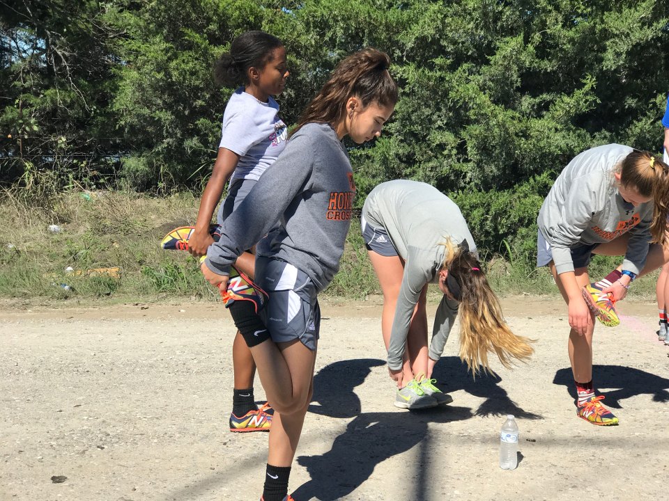 Abby Rubio, 16, warms up with her teammates before a cross country meet in Bonham, Texas.