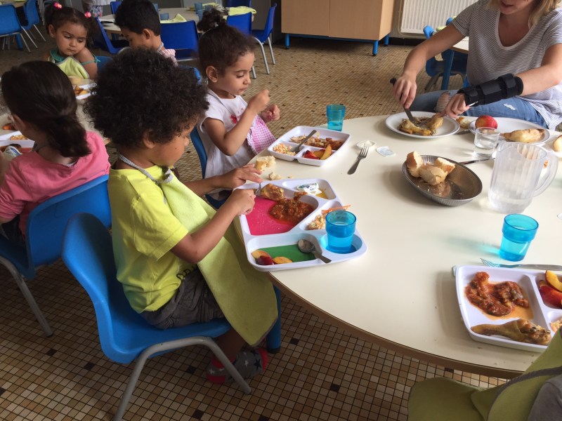 A group of 2- and 3-year-olds enjoy a lunch of fish, ratatouille, fresh bread and fruit at a preschool program in Lormont, a suburb of Bordeaux.