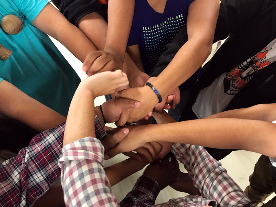 Taos High students work together to untie a “human knot” during an icebreaker led by seniors during the school’s 2018 EQ Retreat.