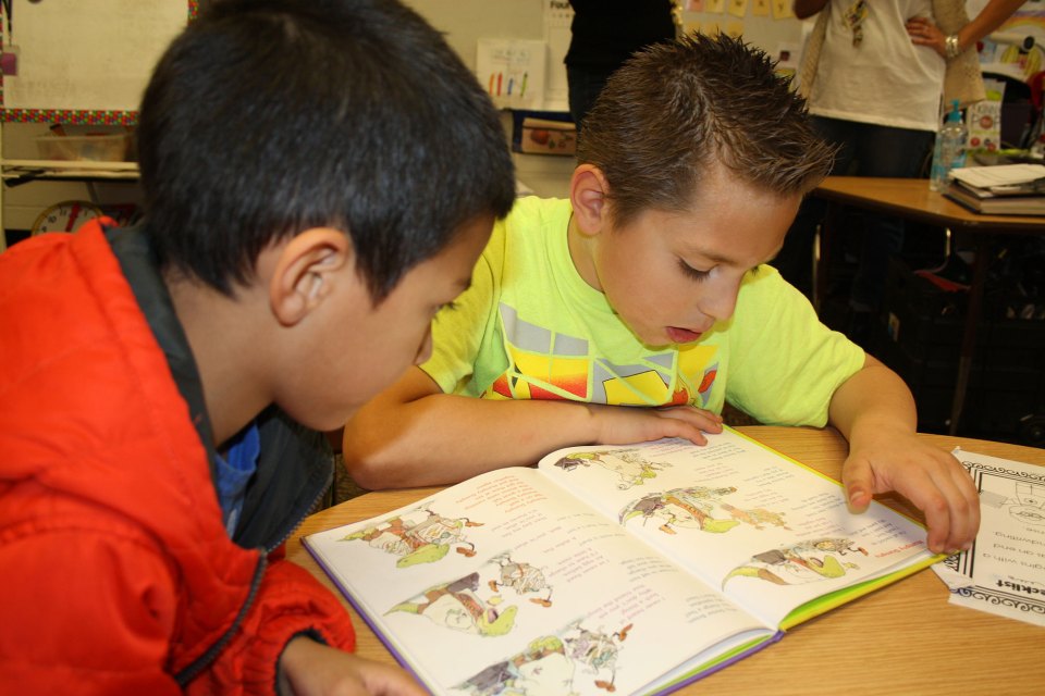 Third-graders at Alamosa Elementary School in Albuquerque practice reading with first-graders in Carrie Ramirez’s classroom.