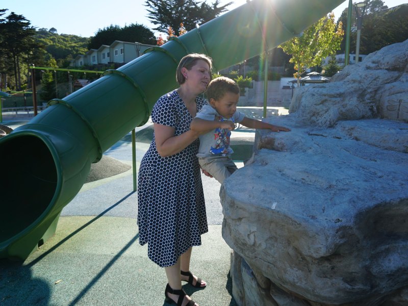 Lynette Stewart lifts her son Quincy, 3, up to a rock at George Rocky Graham Park in Marin City, California.